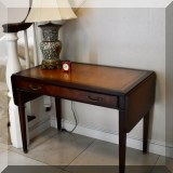 F02. Paine Furniture mahogany drop leaf leather top table. 28”h x 38”w x 22”d (Drop leaves are each 10”w) 
